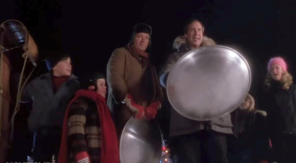 Image of Clark Griswold and his super-fast sled in Christmas Vacation.