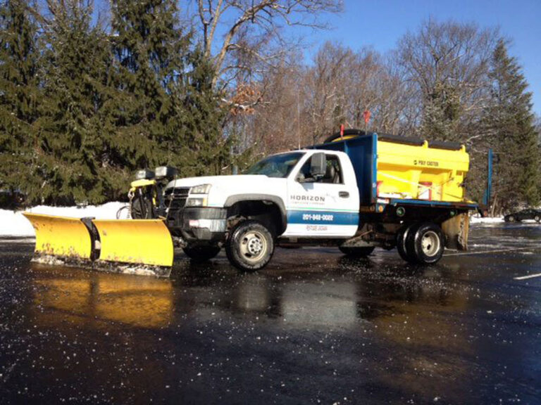 Photo of a snow plow with Horizon Landscape logo on the truck